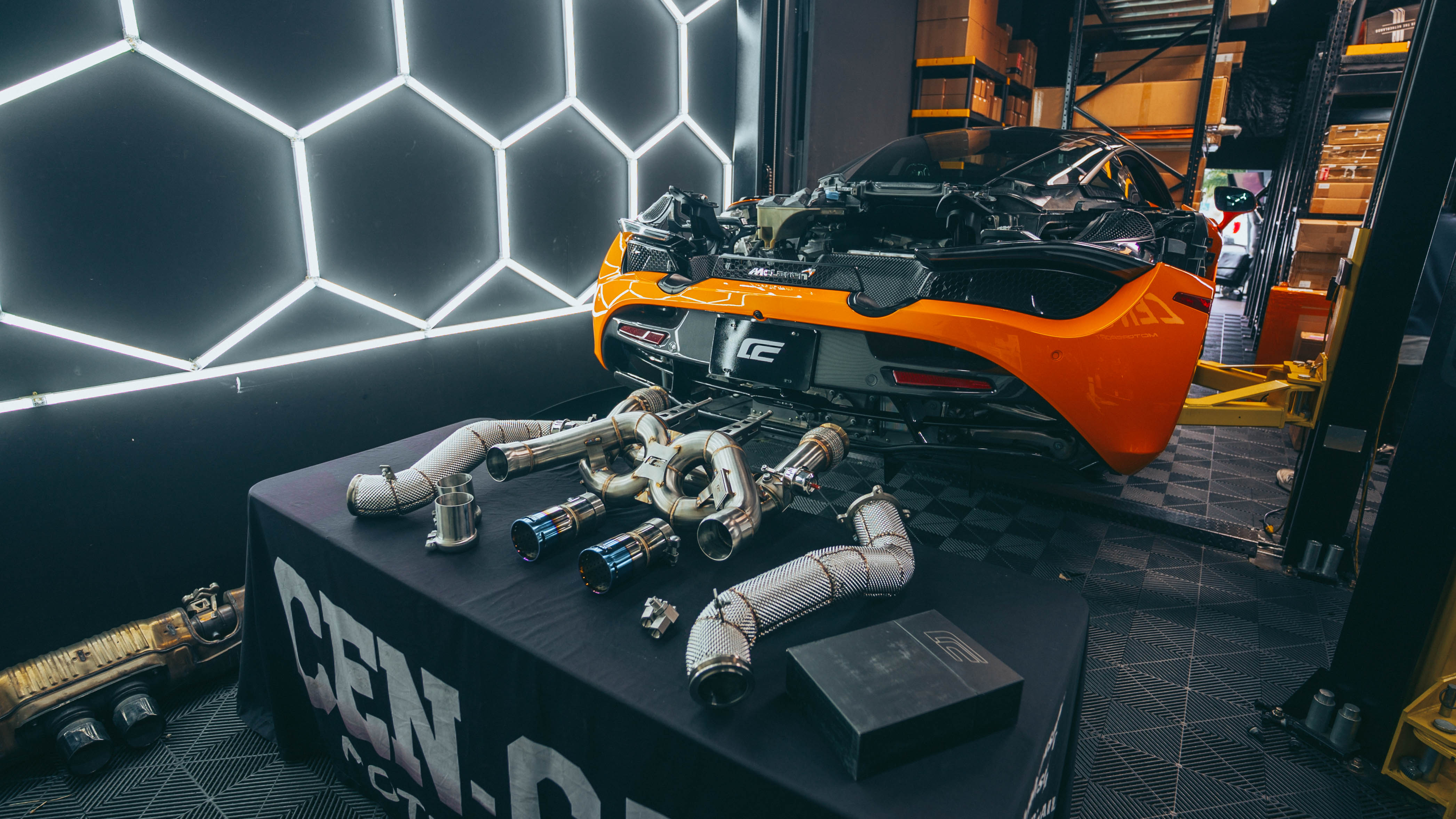 McLaren 720S exhaust fitment detail showing OEM mounting points
