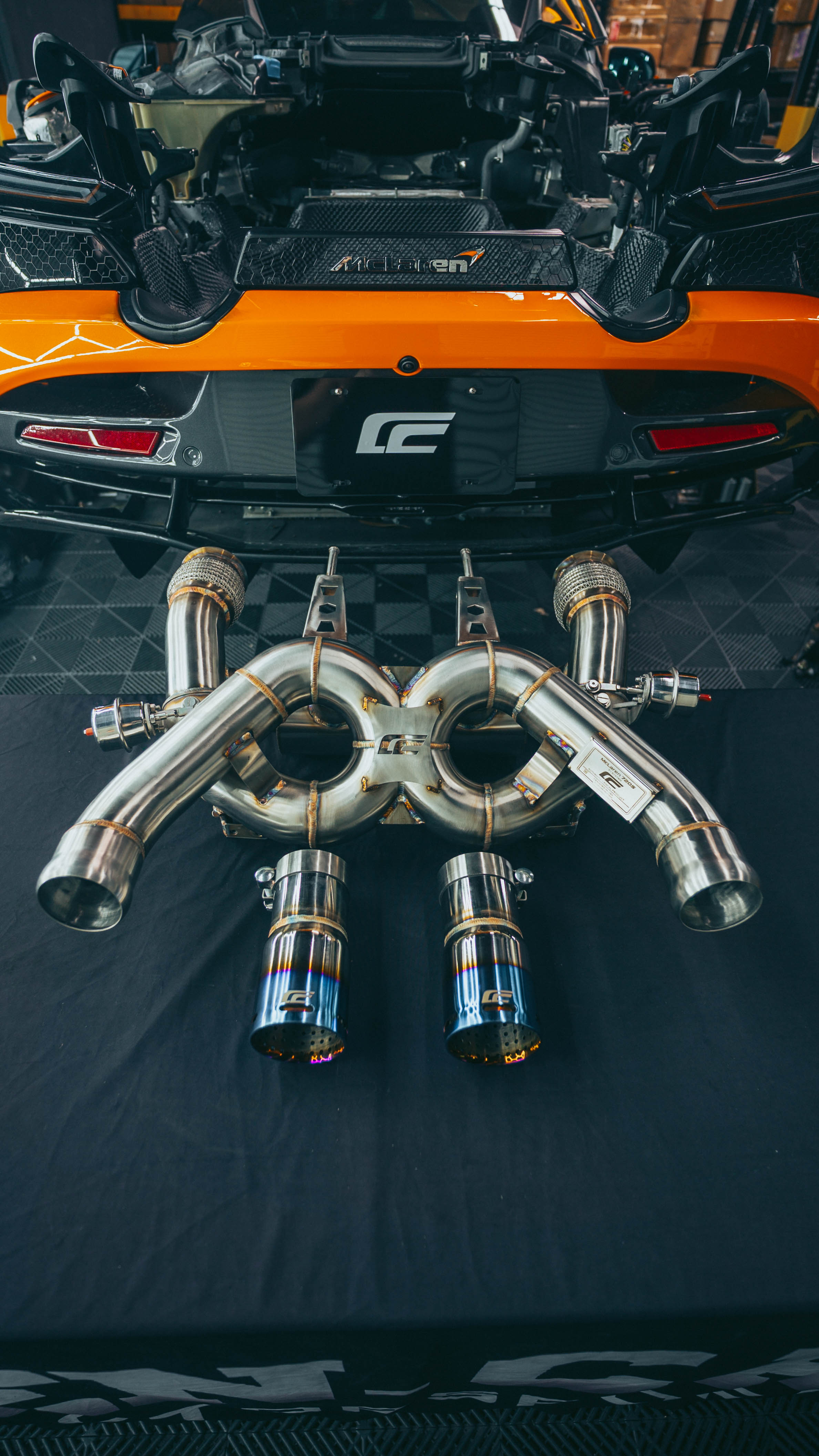 McLaren 720S exhaust titanium tips close-up with heat gradient blue purple finish