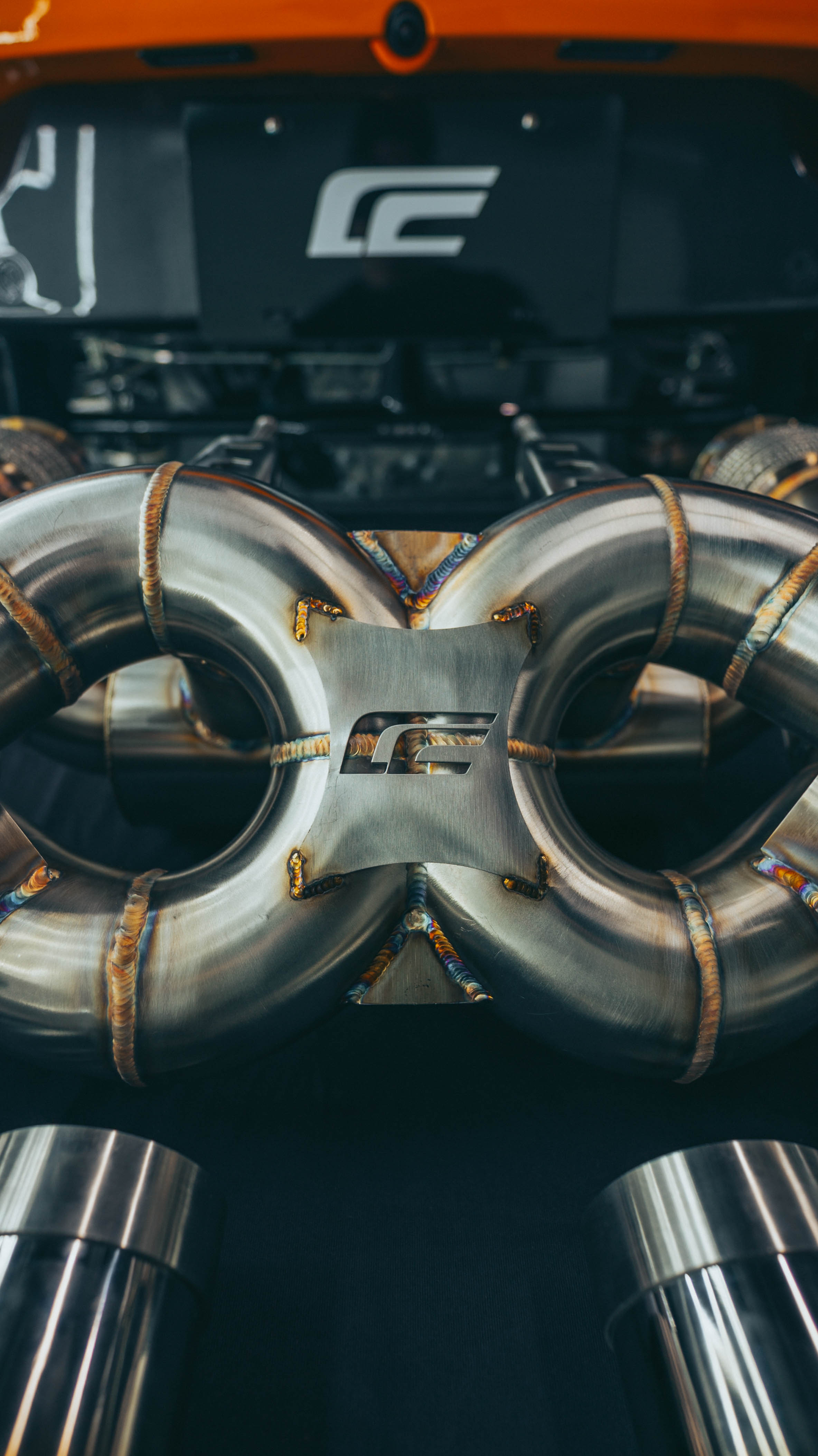 McLaren 720S exhaust X-pipe section top-down view showing symmetrical design